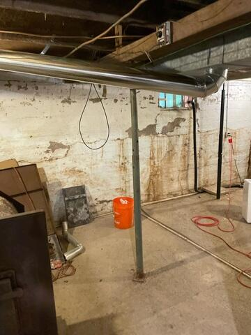 Basement foundation area with adjusted sewage pipes and reinforced support columns in Kettle River, MN.