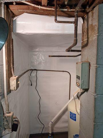 CleanSpace vapor barrier installed on the concrete foundation walls of a basement utility area in Chanhassen, MN.