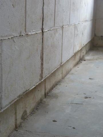 Shearing at the bottom row of a concrete block foundation wall