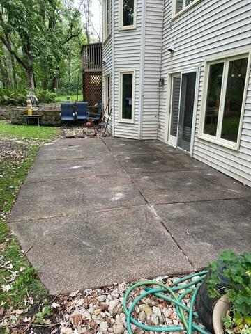 Sinking concrete backdoor patio slab causing a pooling water puddle before repair in Anoka MN