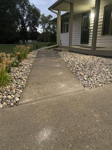 Concrete walkway leading to an Eau Claire WI home before professional leveling service