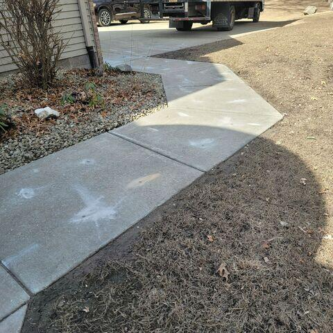 Level and restored concrete walkway walkway with clean injection points in Hudson WI after repair