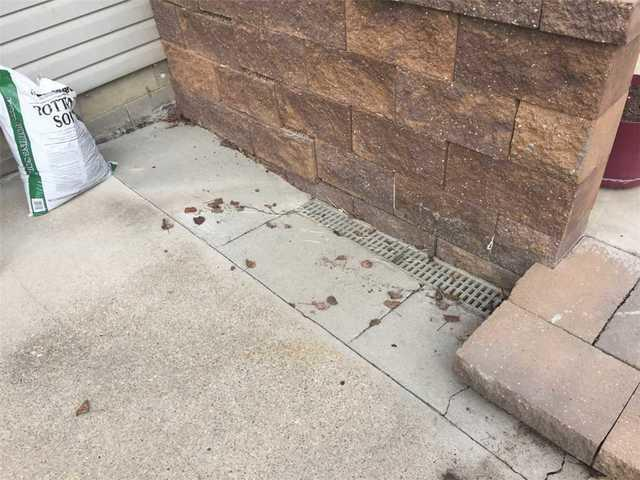 Cracked outdoor concrete sidewalk before leveling and waterproofing repair in Bemidji MN