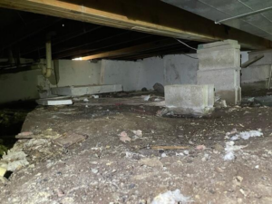 Damp crawl space before encapsulation in McGrath, MN