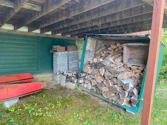 Under cabin clearance showing wooden beams and temporary supports on a hill in Hackensack Minnesota
