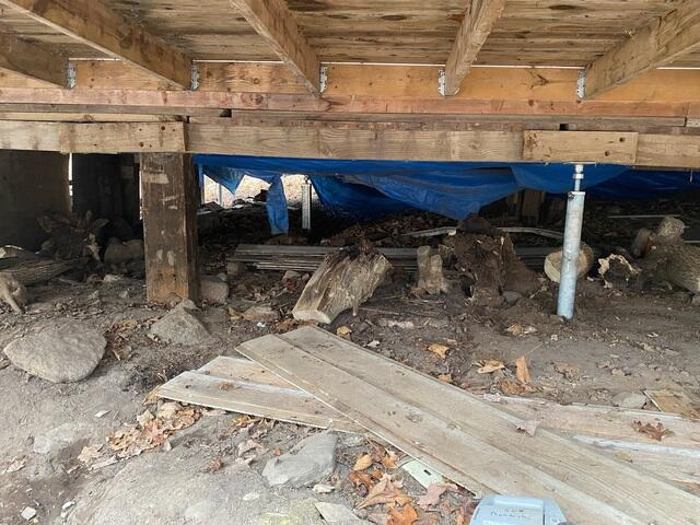 SmartJack system installed under a main beam with wood blocking for foundation repair in Winter Wisconsin