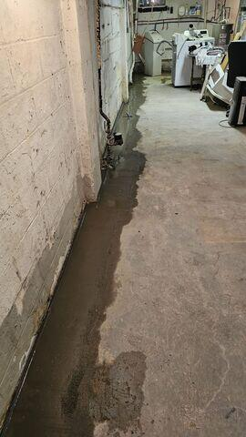 Water seeping onto the basement floor in Remer MN before waterproofing
