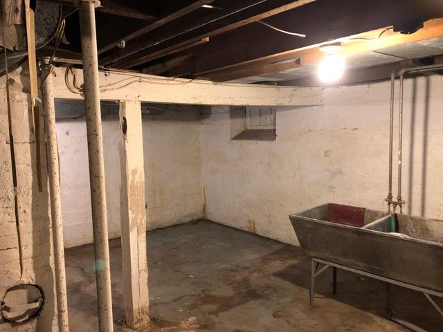 old-unfinished-basement-sagging-support-beam-grantsburg-wi.jpg