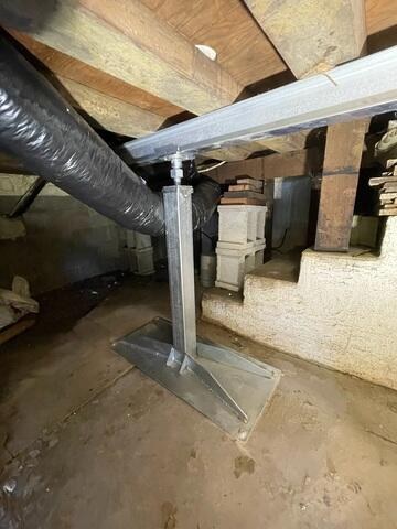A newly installed high-capacity galvanized steel SmartJack adjustable support column mounted beneath a horizontal steel beam in a crawl space in Richfield, MN.