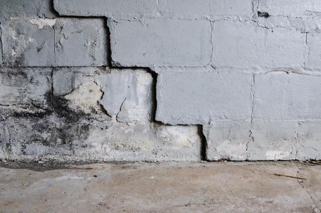 Stair-step cracking forming along the mortar joints of a block foundation